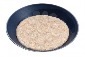 cooked porridge from wheat groats (crushed partly hulled wheat grains) in gray bowl isolated on white background