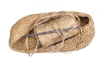 hand-knitted bottom of bag with spool of hemp twine and crochet isolated on white background
