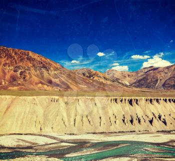 Vintage retro effect filtered hipster style travel image of Himalayan landscape in Hiamalayas near Baralacha La pass with grunge texture overlaid. Himachal Pradesh, India