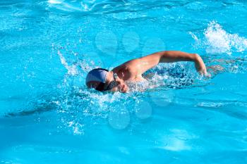 Athletic Man swimming in the pool