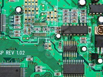 Electronic microcircuit with microchips and capacitors taken closeup.