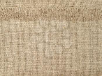 Natural linen texture pattern with fringe suitable as abstract background.