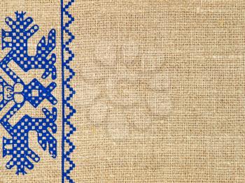 Linen texture with russian traditional ornament taken closeup as abstract background.