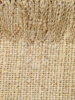 Natural linen texture pattern with fringe suitable as background.