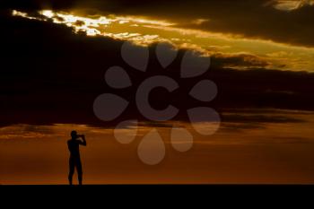 a sunset in the sea  in nosy be madagascar, a man taking a photo