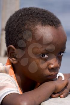 a sad little boy in a boat in zanzibar
