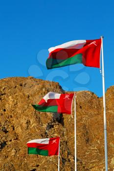 and the cloudy sky in oman waving flag mountain