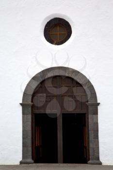  lanzarote  spain canarias brass brown knocker in a   closed wood  church door and white wall abstract 
