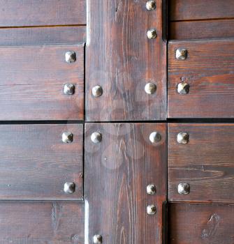 vanzaghello abstract  rusty brass brown knocker in a  door curch  closed wood lombardy italy  varese