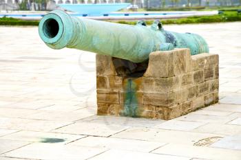 bronze cannon in africa morocco  green  and the old pavement
