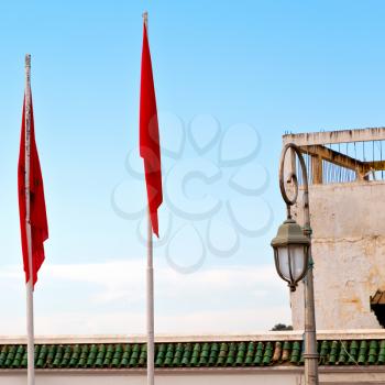 waving flag in the blue sky tunisia  colour and wave battlements