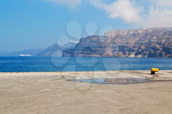 in europe greece santorini island hill and rocks on the summertime beach 