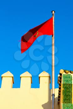 waving flag in the blue sky tunisia  colour and wave battlements