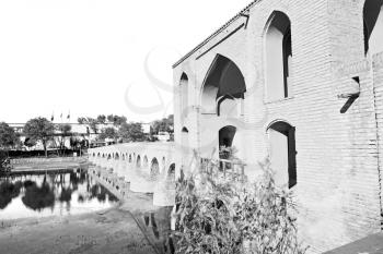 blu in iran  the old bridge and the river antique construction near nature