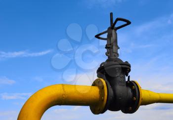 Valve on the gas pipe on the background of blue sky