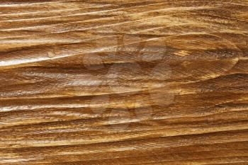 Relief wooden board surface is coated with varnish