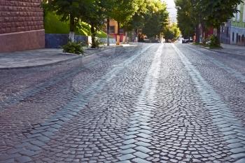 Wide cobbled road in old town at the summer morning. Lviv, Ukraine
