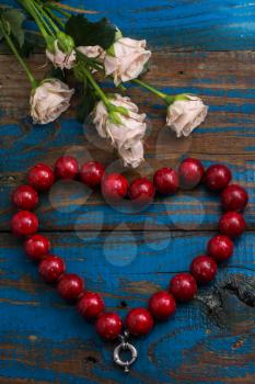 coral beads laid out in the shape of heart