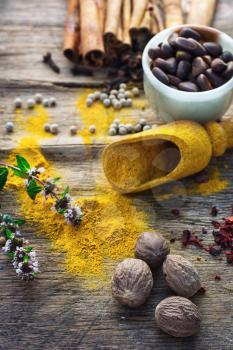 Set of different spices on the old wooden table.Photo rustic