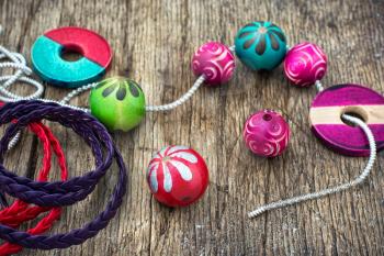 Wooden beads and accessories for needlework on old wooden  background