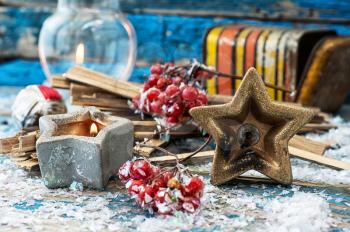 Christmas decoration on light blue background covered in snow