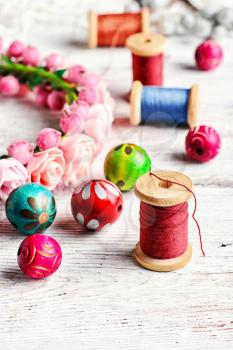 Round colored beads,spools of threads for needlework