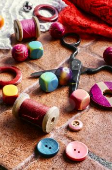 Set for needlework from thread and beads on a stone background