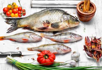 Catch of fisherman with carp and perch on the kitchen table