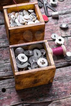 set of buttons from the clothing in wooden boxes in retro style