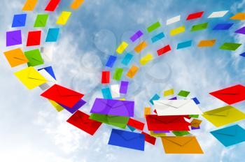 Colorful envelopes stream against the blue sky as a metaphor of happy chain letters
