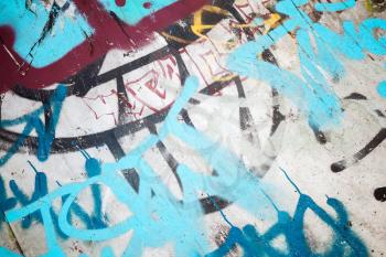 Abstract colorful graffiti fragment over old urban concrete wall, vintage tonal photo filter effect, retro style