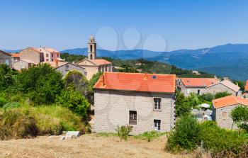 Corsican village landscape, living houses and bell tower. Petreto-Bicchisano, Corsica, France