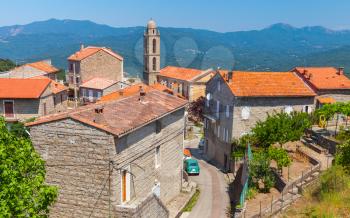 Small Corsican village landscape, living houses and bell tower. Petreto-Bicchisano, Corsica, France