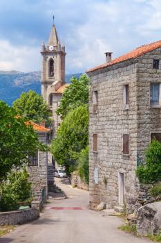 Typical Corsican village street landscape, old living houses and bell tower. Zonza, South Corsica, France