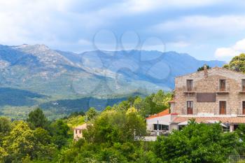 Rural Corsican landscape, old stone houses and mountains on the horizon. Zonza, Corsica, France
