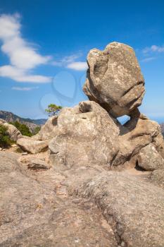 Big round stone lays on top of a mountain, Corsica island, Ospedale region