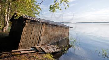 Small old wooden boat garage on the coast of Saimaa lake, typically construction for Finland