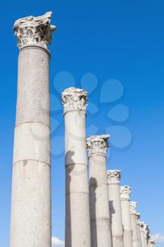 Ancient columns on blue sky background, fragment of ruined roman temple in Smyrna. Izmir, Turkey