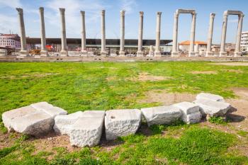 White stones and columns on a background, ruins of Ancient city Smyrna. Izmir, Turkey