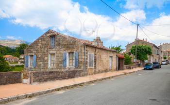 Street view with old stone living houses of Aullene village, Corsica, France