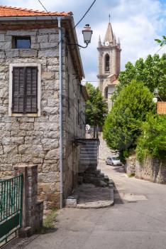 Corsican village street view, old living houses and bell tower. Zonza, South Corsica, France
