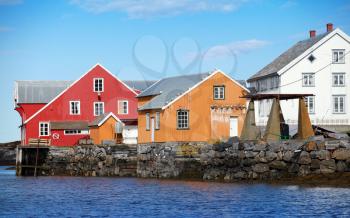 Traditional Norwegian village with colorful wooden houses on rocky coast