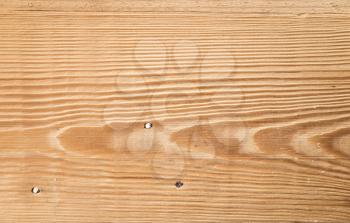 New wooden plank panel made of pine tree with three nails, flat background texture