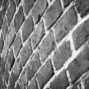 Dark gray round brick wall pattern. Photo background with selective focus