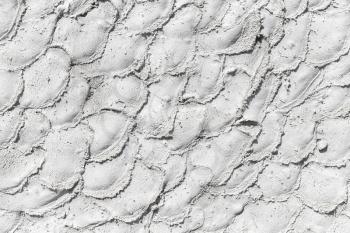 Stone wall with decorative white plaster pattern, background photo texture