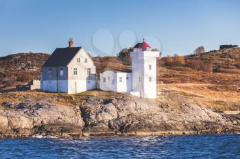 Terningen Lighthouse. White navigation tower with red top located in Hitra Municipality, Trondelag county, Norway