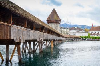 Chapel Bridge with Water Tower, a fortification from the 13th century in old Lucerne city, central Switzerland