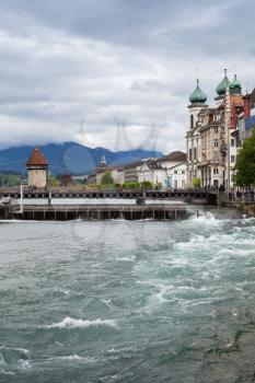 Cityscape of Lucerne city in central Switzerland, Reuss river with Chapel Bridge on horizon