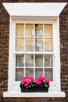 English old town architecture, white window in brown brick wall, background photo texture