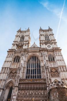 Westminster Abbey main facade under blue sky. One of the most popular landmarks of London, United Kingdom